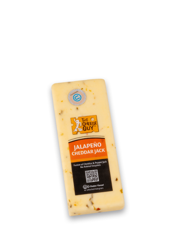 A block of The Cheese Guy Jalapeno Cheddar Jack cheese featuring a label with the product name "JALAPENO CHEDDAR JACK" in bold orange letters, along with the company logo and visible flecks of jalapeno peppers throughout the cheese.