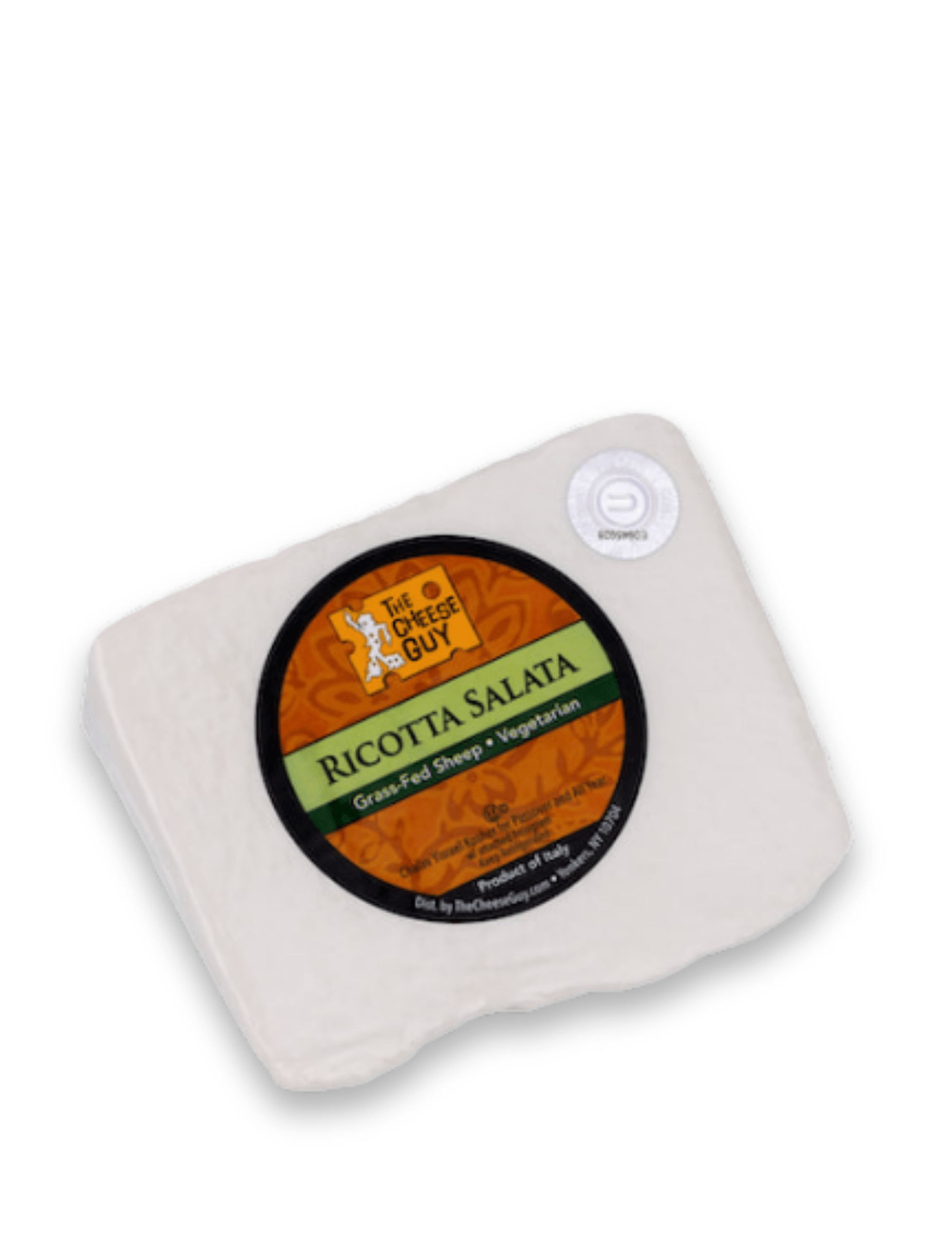 A wedge of The Cheese Guy Ricotta Salata cheese features a circular black and orange label with the product name in bold green letters, indicating it's made from grass-fed sheep and is vegetarian.