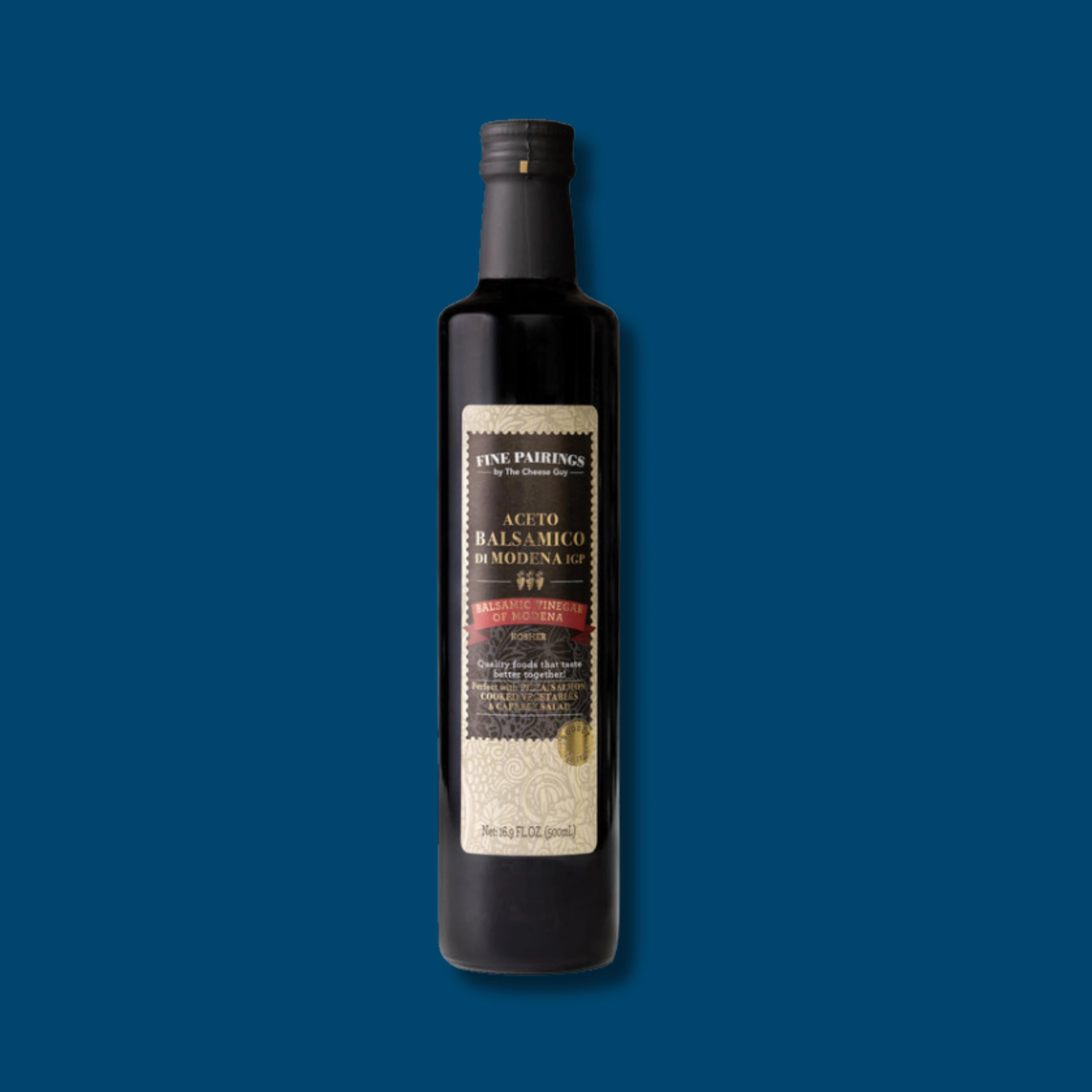The Cheese Guy Fine Pairings Kosher Balsamic Vinegar of Modena IGP is in a sleek, dark glass bottle with a black cap, showcasing its label with product details and certifications against a dark blue background.