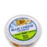 Image of The Cheese Guy Blue Cheese Crumbled, packaged in a round plastic container, showing the brand logo, 'Blue Cheese Crumbled' product name, and attributes like 'All Natural' and 'Antibiotic Free'.