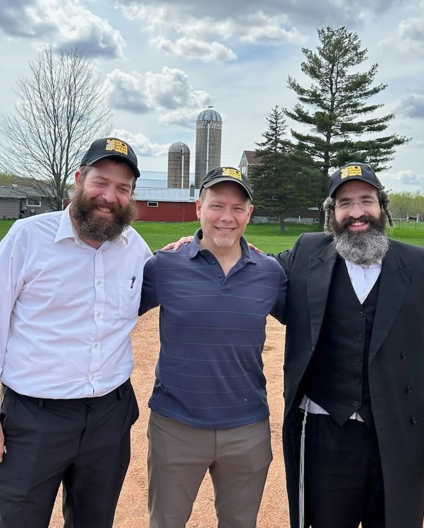 3 People Standing wearing The Cheese Guy's hat one of it is Brent Delman located at the center.