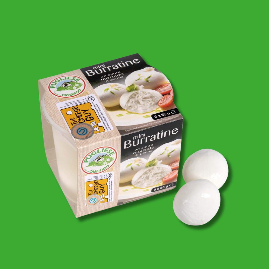 The Cheese Guy Mini Burratine packaging, featuring three small, white balls of burrata cheese with a tomato and basil leaf illustration, labeled "mini Burratine un cuore morbido di panna," alongside The Cheese Guy logo, with three individual mini burratine balls shown separately against a green background.