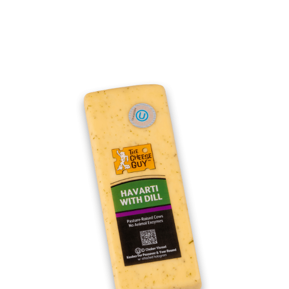 Image of The Cheese Guy Havarti with Dill, a light yellow cheese with visible dill flecks, in a rectangular block, showing the brand logo and product information on the label.