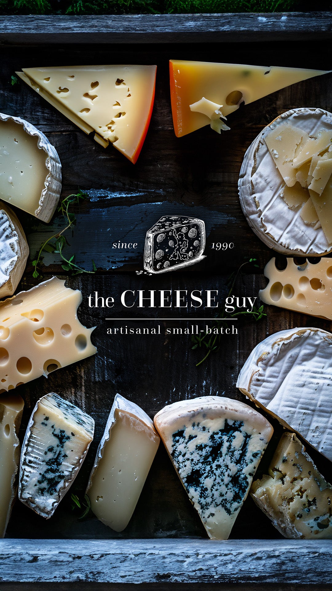 Showcase of The Cheese Guy's artisanal, small-batch cheeses.  Assorted varieties are arranged around the brand's logo on a dark, textured surface.