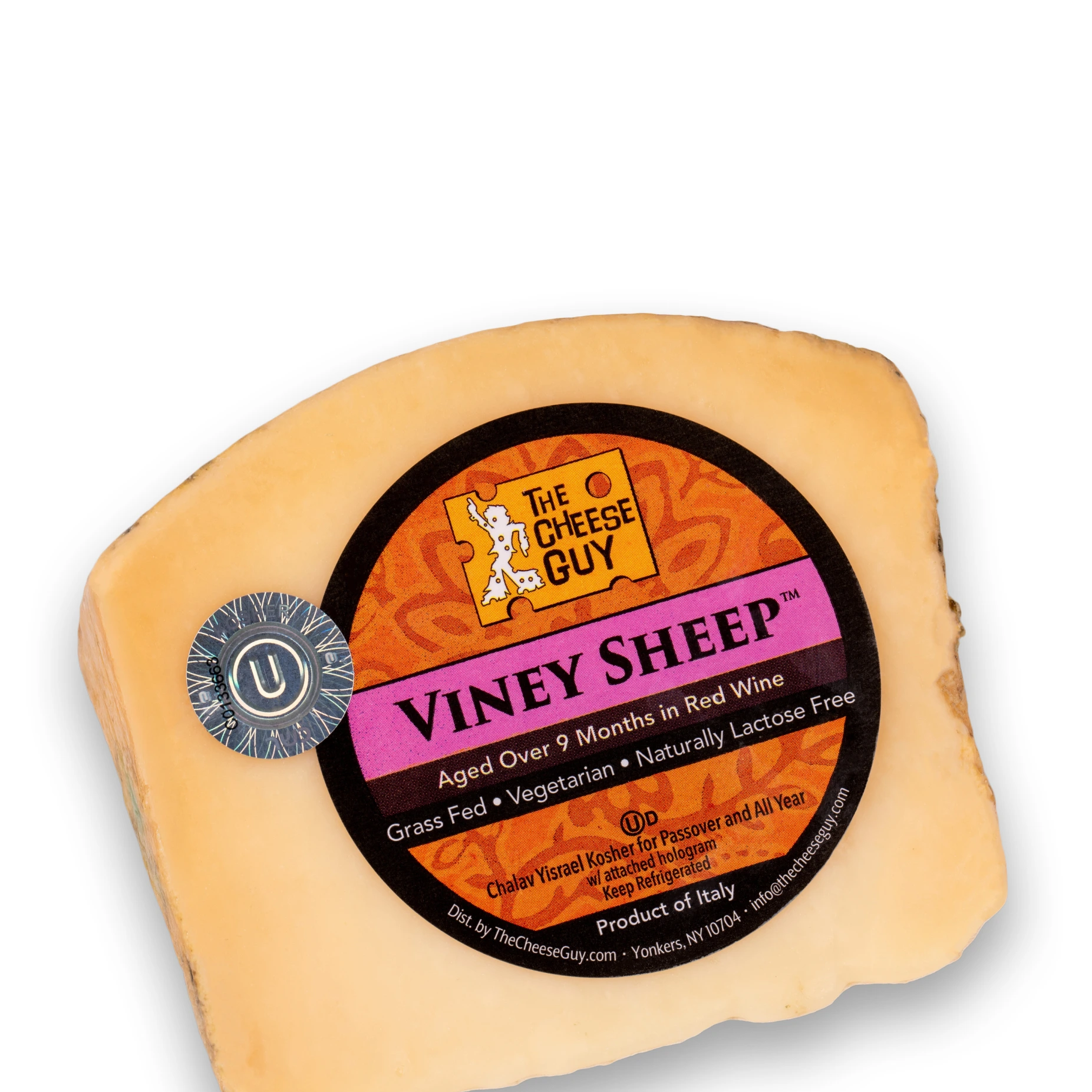 A wedge of The Cheese Guy Viney Sheep cheese, aged over 9 months in red wine, featuring a circular orange and black label with the product name in bold pink letters, indicating it's made from grass-fed sheep, vegetarian, and naturally lactose-free.