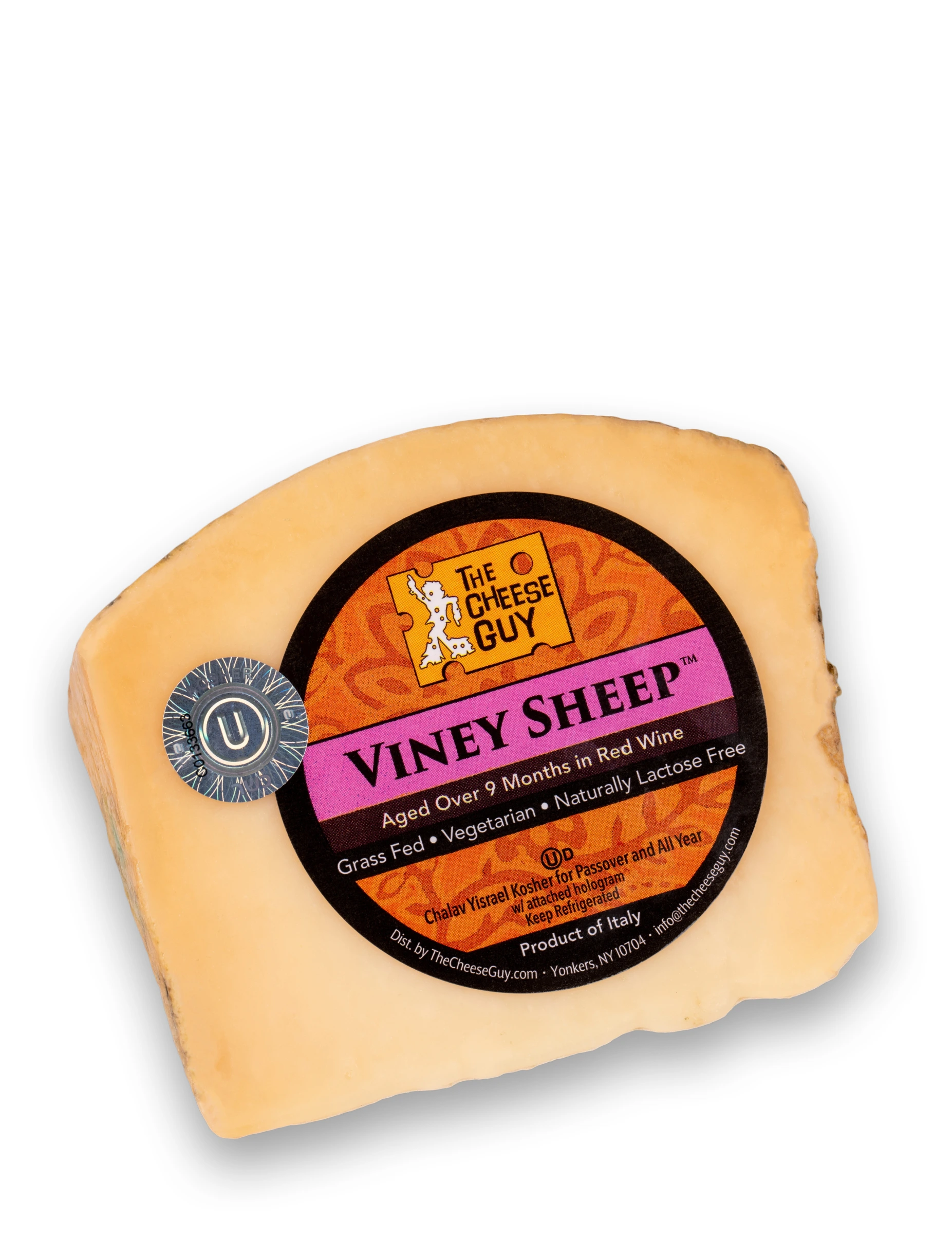 A wedge of The Cheese Guy Viney Sheep cheese, aged over 9 months in red wine, featuring a circular orange and black label with the product name in bold pink letters, indicating it's made from grass-fed sheep, vegetarian, and naturally lactose-free.