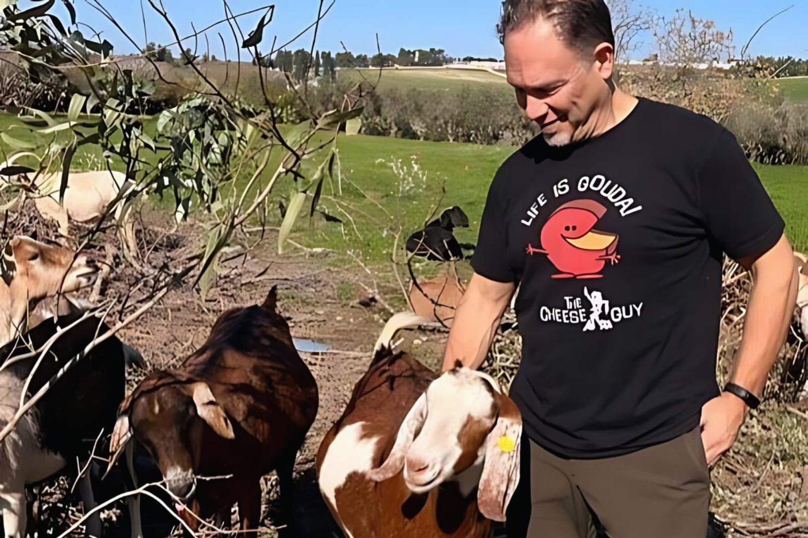 Brent Delman on a farm with the happy goats