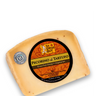 A wedge of The Cheese Guy Pecorino al Tartufo cheese features a circular black and orange label with the product name in bold letters, indicating it's made from grass-fed sheep and is vegetarian, with visible black truffle pieces throughout the cheese.